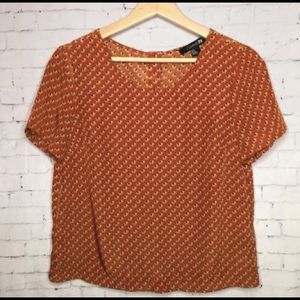 Orange elephant button down back top